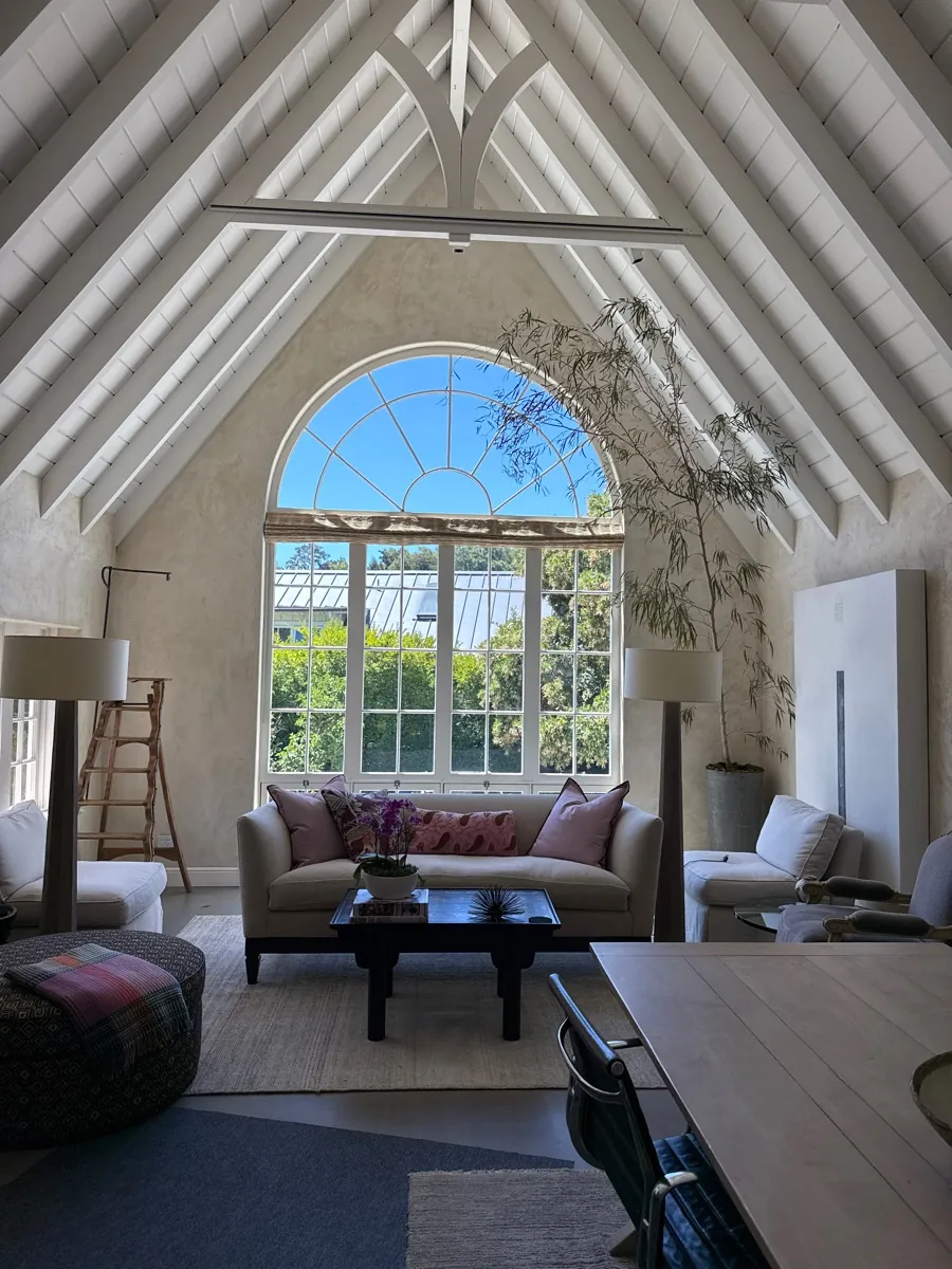 Vaulted living room with an arched window wall, solar film on every pane