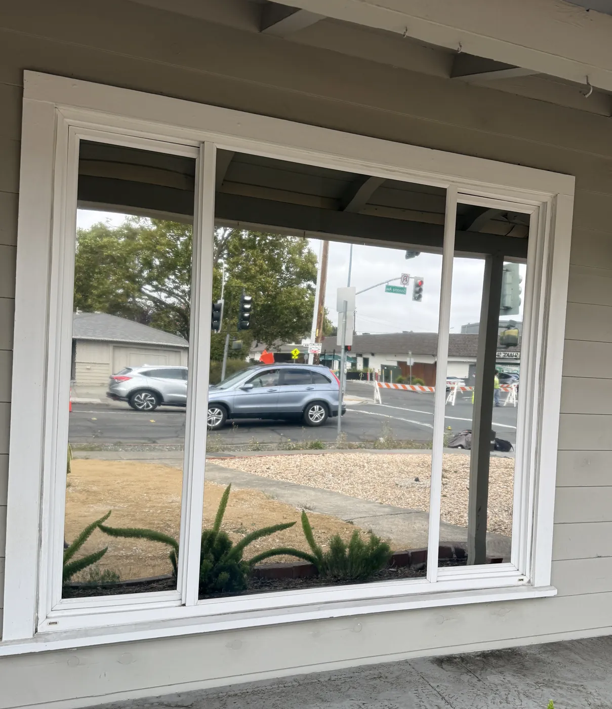 The same front window after R Silver 20X exterior mirror film: the street reflected, the room private